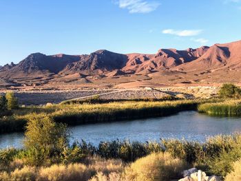 Scenic view of lake and mountains against sky