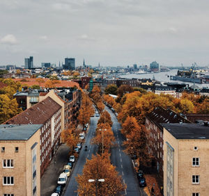 High angle view of street amidst buildings against sky