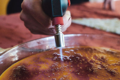 Close-up of hand holding glass of water