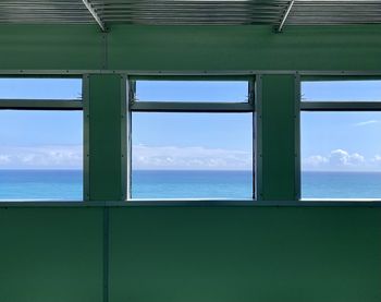 Scenic view of sea against sky seen through window