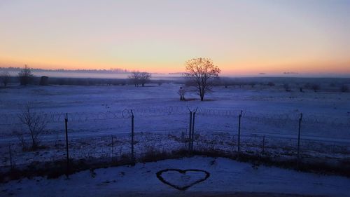 Scenic view of snowy landscape against sky during sunset
