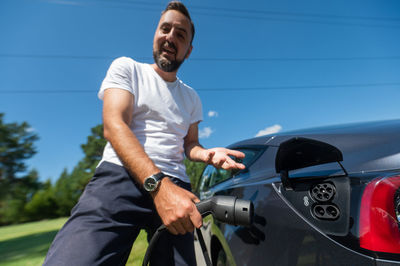 Low section of man holding car