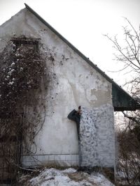 View of horse standing on snow covered building