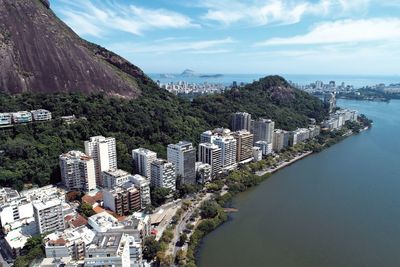 High angle view of buildings by sea against sky