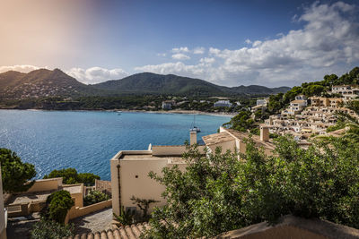 Scenic view of sea and mountains against sky