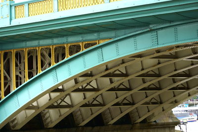 Low angle view of railway bridge against blue sky