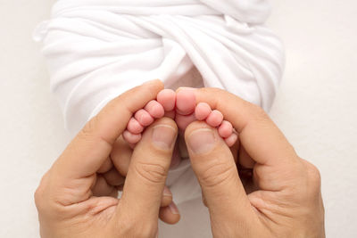 Midsection of couple holding hands