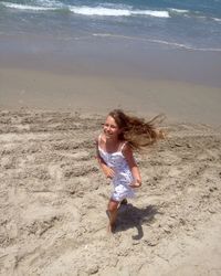 Full length of young woman on beach