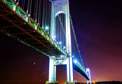 Low angle view of bridge against sky at night