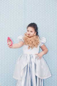 Girl in costume holding mirror