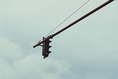 Low angle view of crane against sky