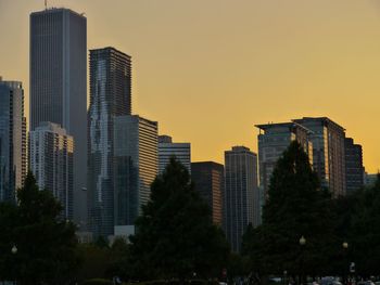 Low angle view of skyscrapers against sky during sunset