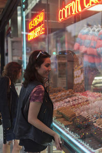 Young woman looking at a store front