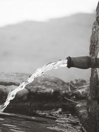 Close-up of water flowing from pipe