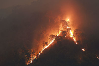 Low angle view of fire in sky at night