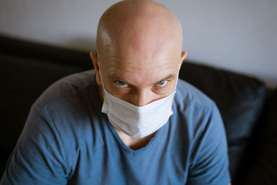 Portrait of a bald man wearing a protective mask