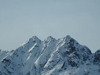 Scenic view of snowcapped mountains against clear sky