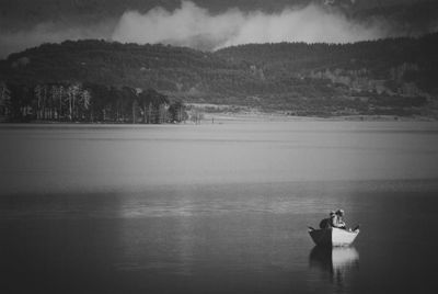 Calm lake with trees in background