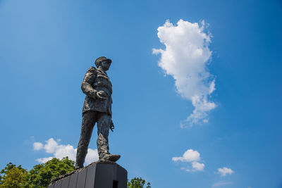 Low angle view of statue against blue sky