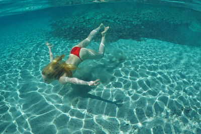 High angle view of woman swimming in sea