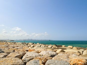 Rocks on sea shore against sky