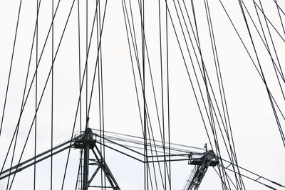 Low angle view of electricity pylon against sky