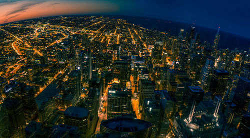 High angle view of city lit up at night