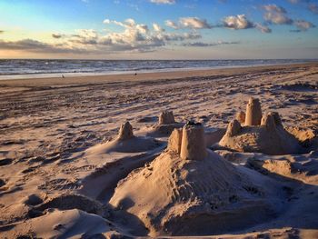 Sand castle on beach against sky