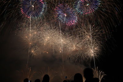 Low angle view of firework display at night