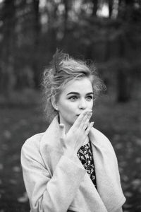 Portrait of young woman standing outdoors