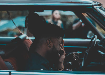 Close-up of man sitting in car