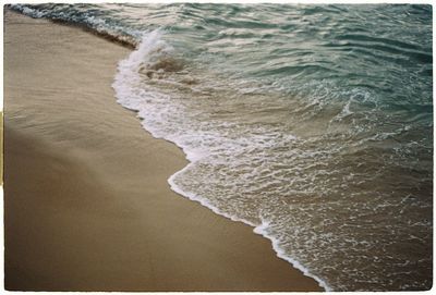 High angle view of waves rushing towards shore