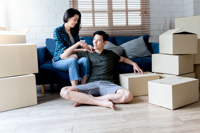 Young couple sitting in box