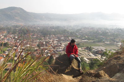 Man looking at view of cityscape