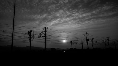 Low angle view of electricity pylon against sky