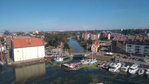 High angle view of town by sea against sky