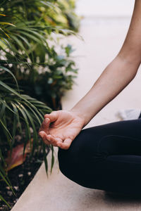 Close-up of hand resting on a knee in meditation