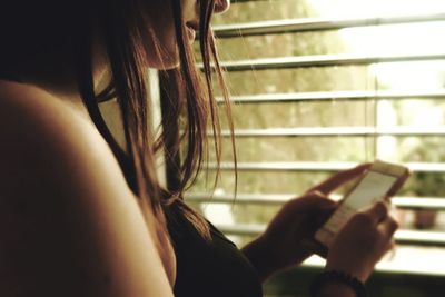 Close-up of woman using mobile phone