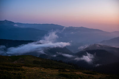 Scenic view of mountains against sky during sunset