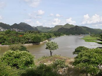 Scenic view of river and mountains against sky