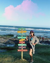 Full length of woman at beach against sky