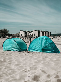 Multi colored umbrellas on beach against sky
