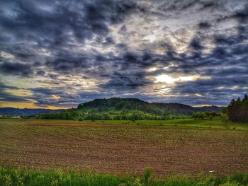 Scenic view of field against sky during sunset