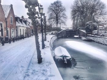 Snow covered houses and trees and buildings in city