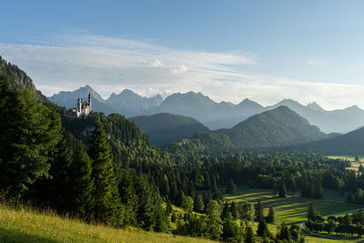 Scenic view of schloss neuschwanenstein with mountains against sky