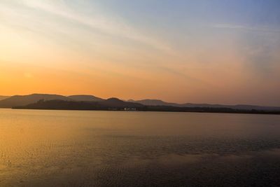 Scenic view of lake against sky during sunset