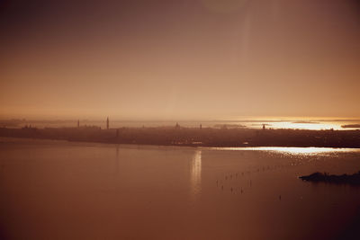 Scenic view of river against sky during sunset