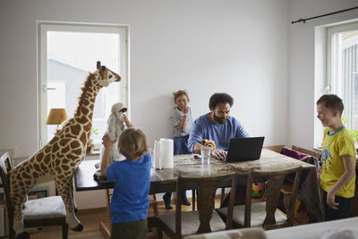 Father working from home and taking care of children