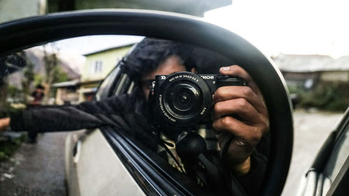 Close-up of man photographing car