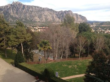 Scenic view of trees and mountains against sky